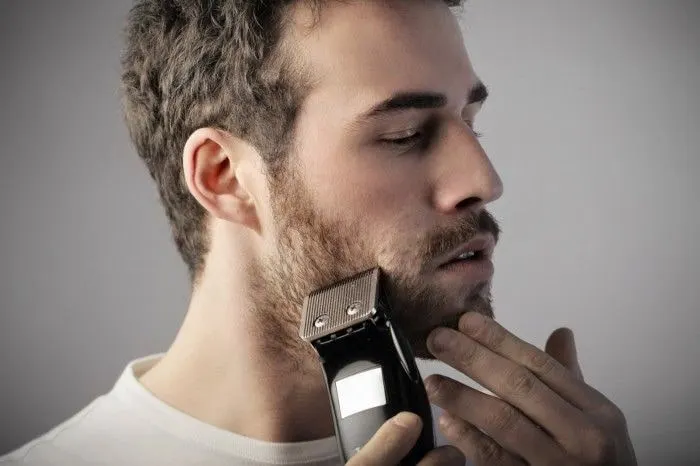 man grooming beard