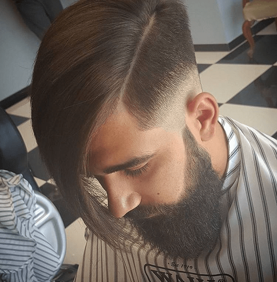 men's hair with side bangs and bushy beard