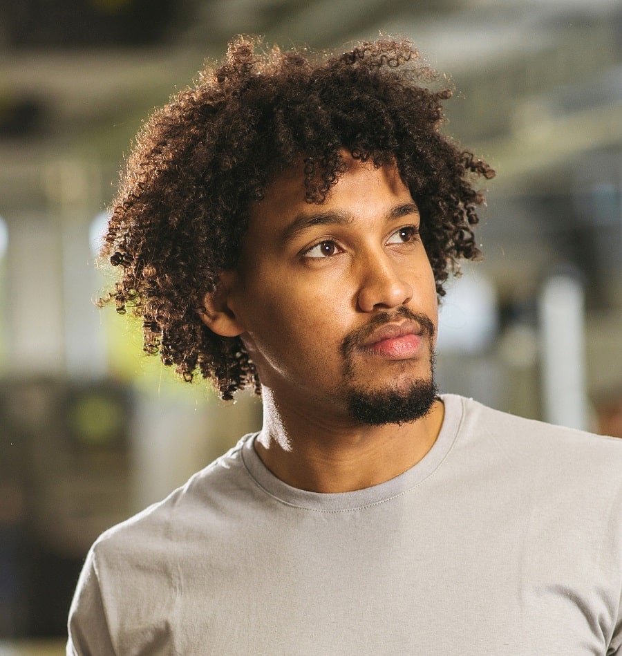 Portrait of man with beard and curly hair stock photo  OFFSET