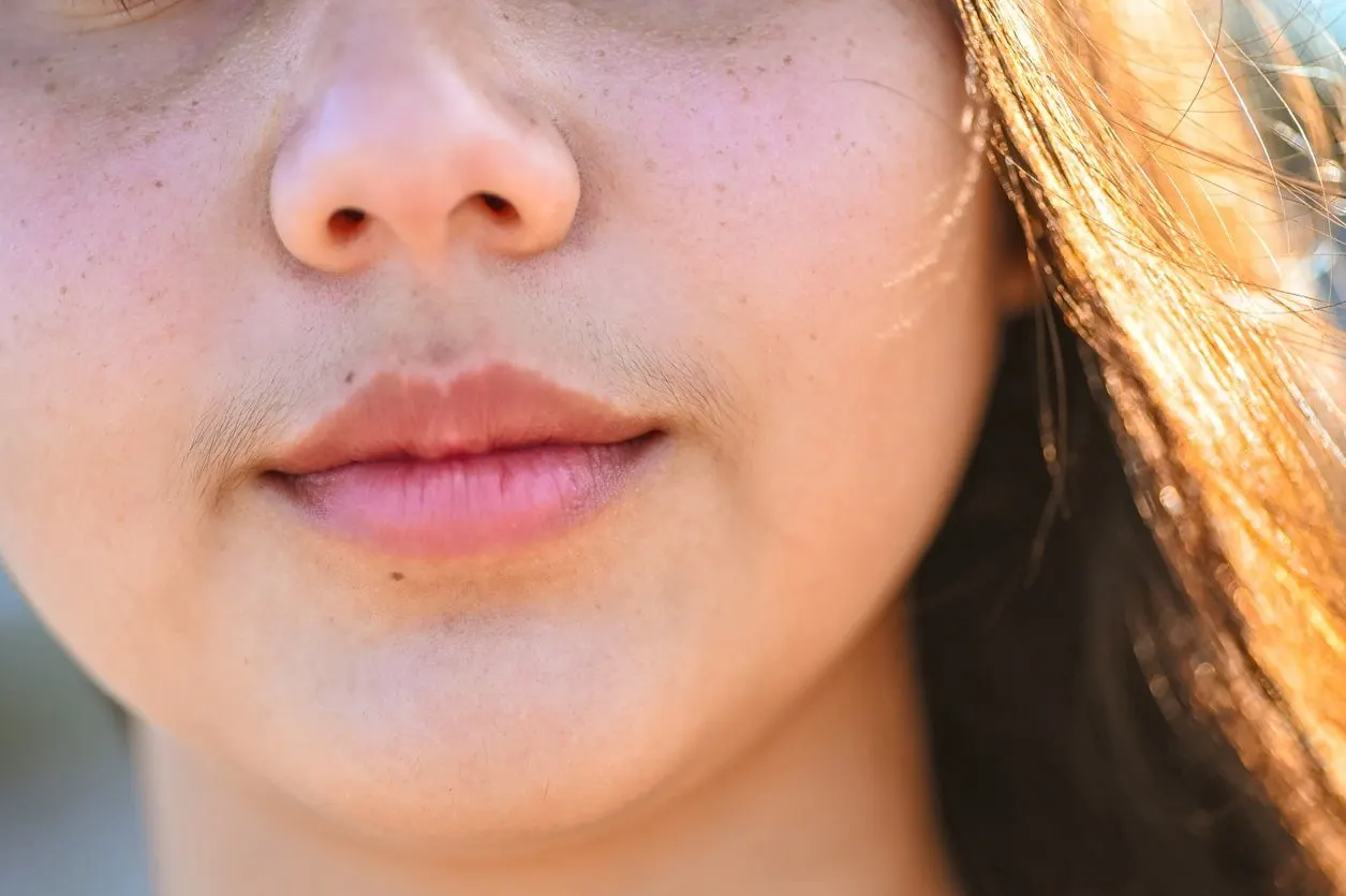 pretty girl with subtle shadow mustache