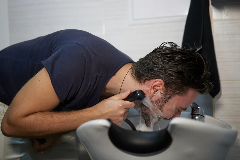 man washing beard