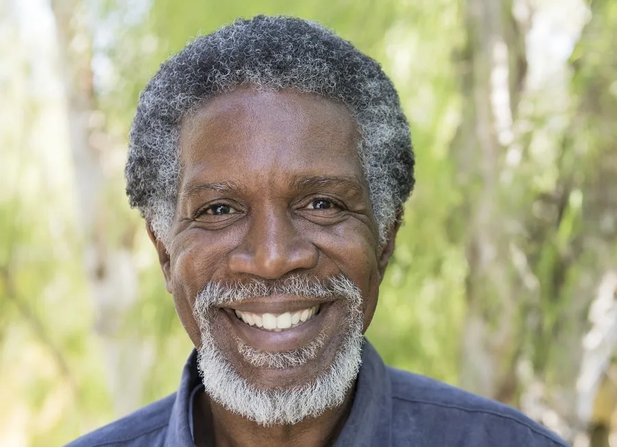 older man with curly hair and beard