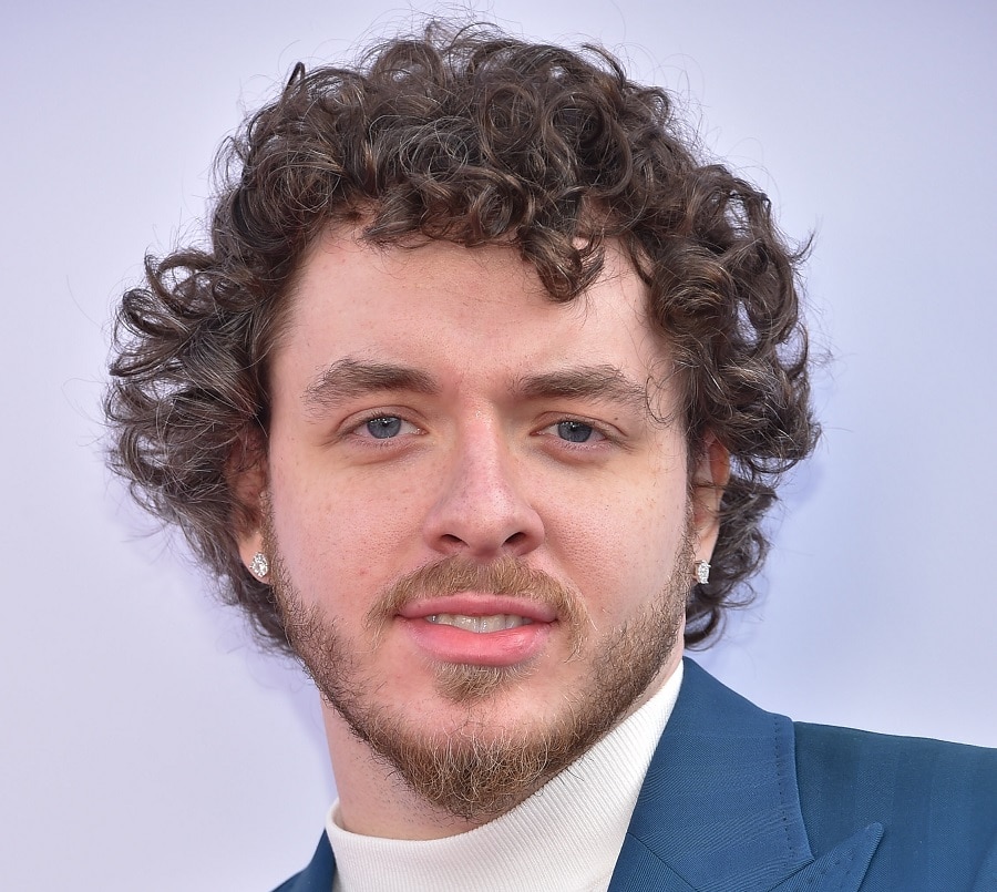 jack harlow with scruffy beard and messy curls