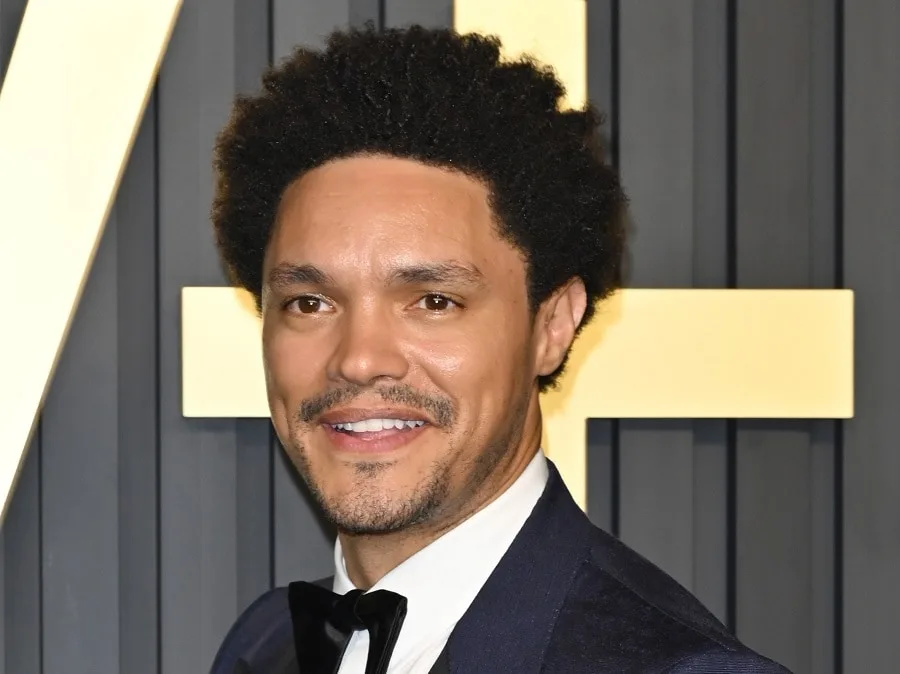 comedian Trevor Noah with light stubble beard