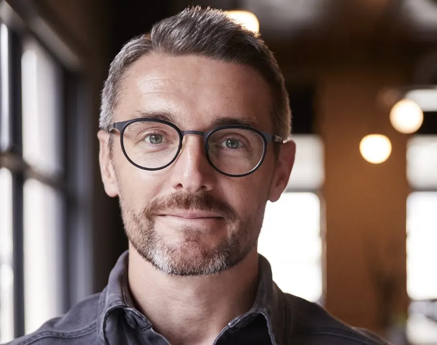 crew cut with glasses and salt and pepper beard