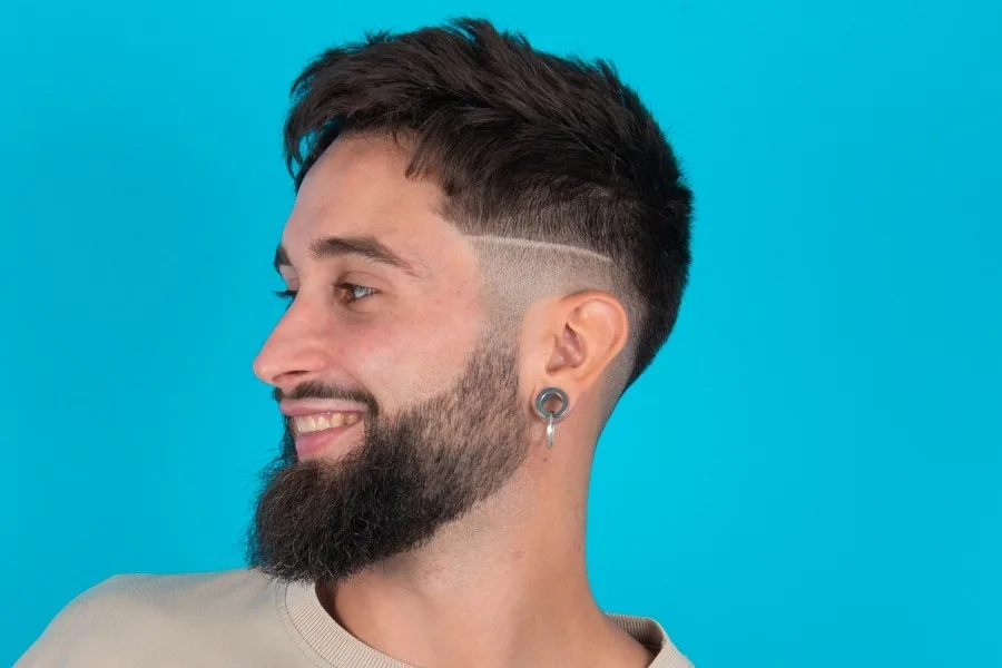 mid taper fade with hard part and beard