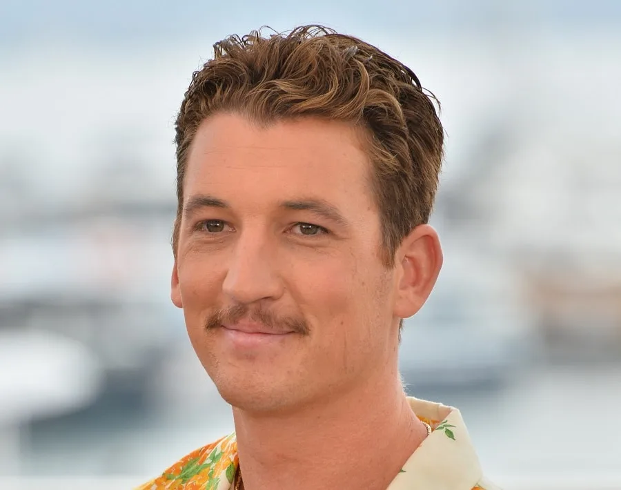 young actor Miles Teller with short mustache