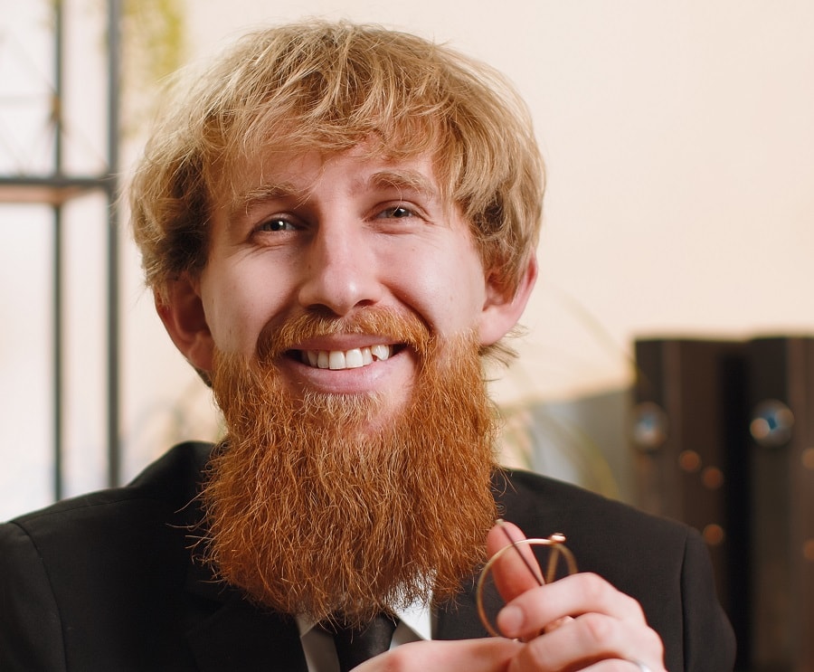blonde layered haircut with red bushy beard