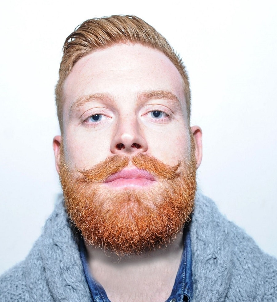 dark blonde combover with red handlebar mustache and beard