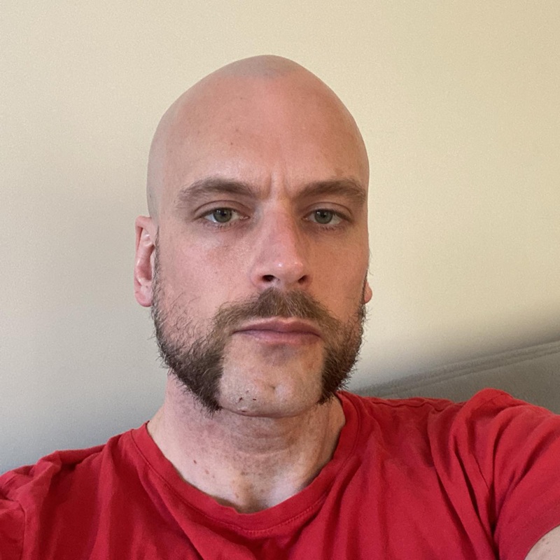 Friendly mutton chops connecting thick sideburns directly to a mustache