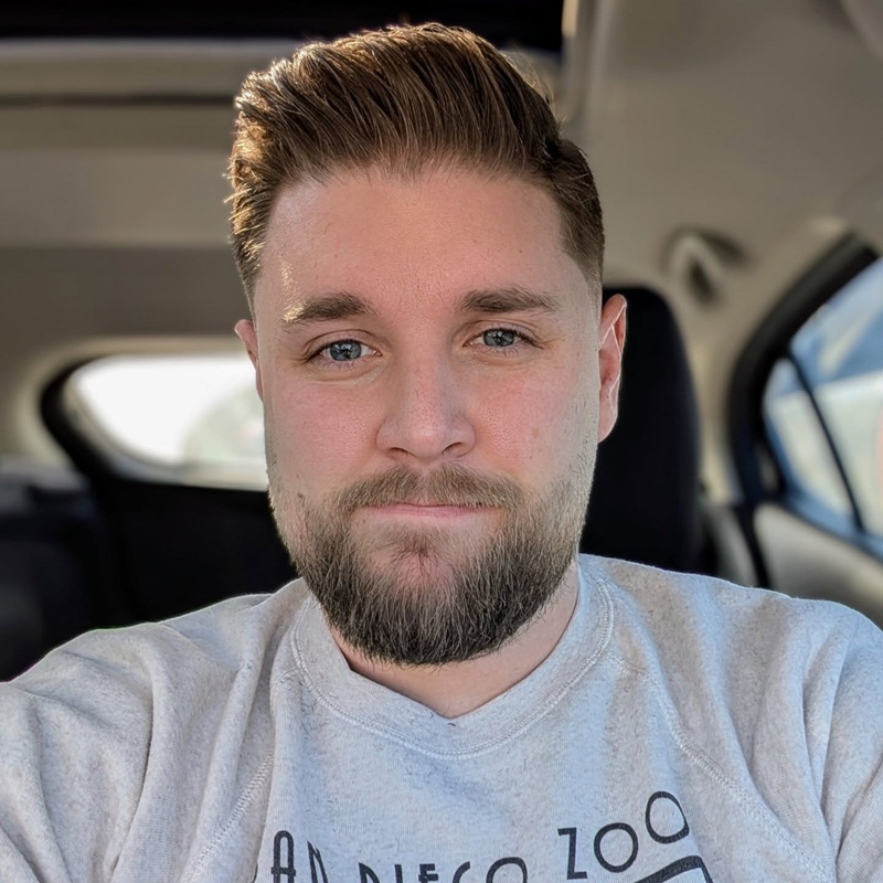short full beard closely following the natural jawline of a round face