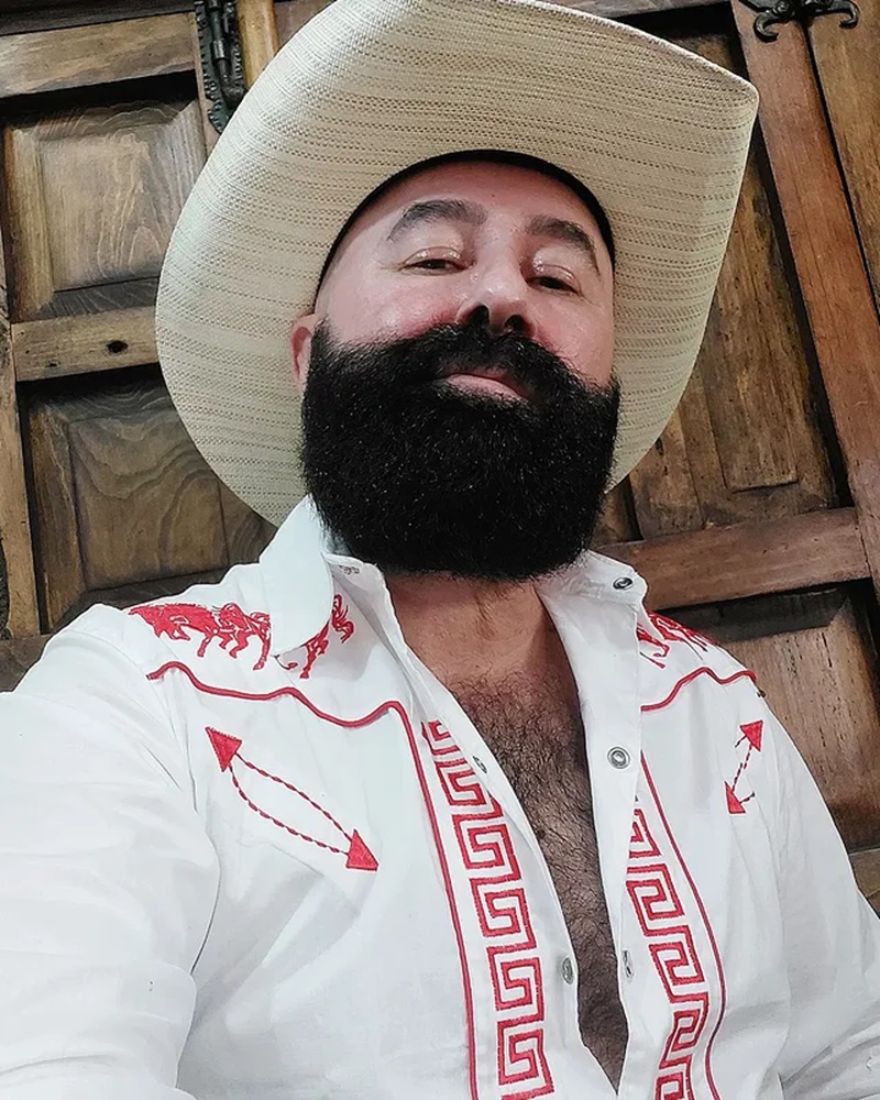 Dense, thick dark cowboy beard and mustache